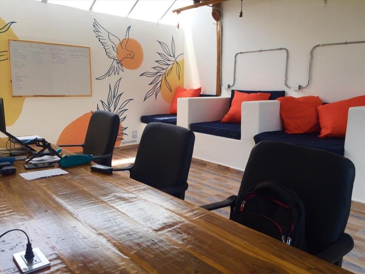 Professional meeting room at Escazu Corporate Center with white table and black chairs.