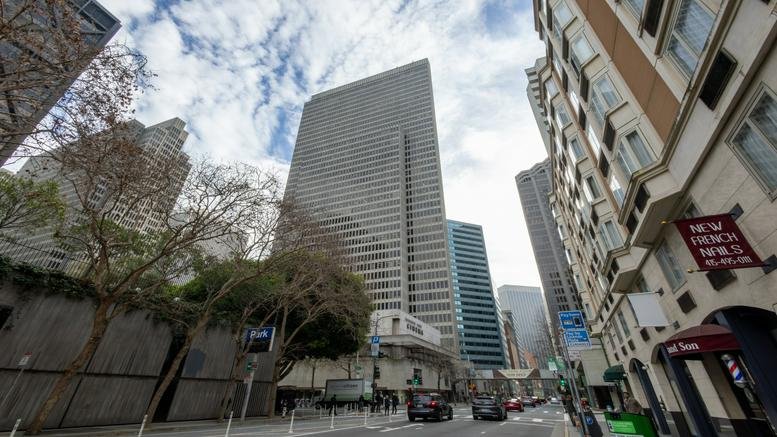 Exterior view of the towering glass facade at Four Embarcadero Center against a cloudy sky.