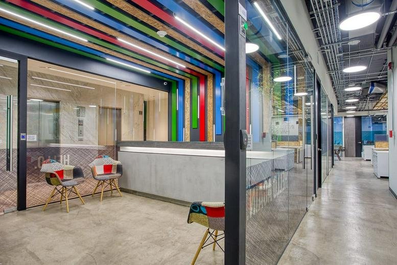 Colorful reception area at Hamburgo 182, Col. Juárez, Del. Cuauhtémoc, Mexico City with a modern concrete desk.