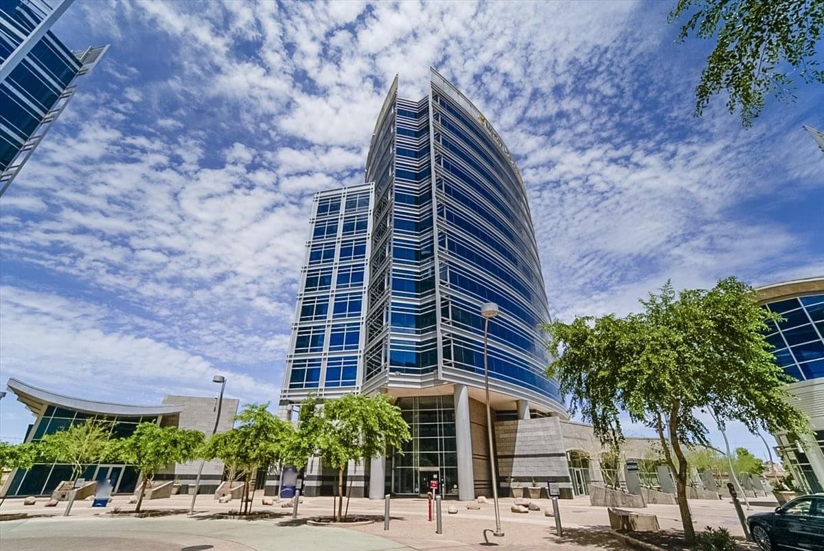Exterior view of the modern glass-facade Hayden Ferry Lakeside Center under a blue sky.