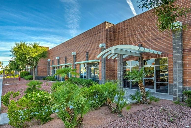 Exterior view of the brick facade and modern glass entrance at (HEN) Augusta Park.