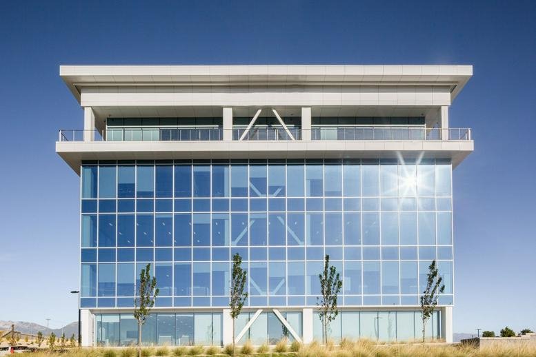 Exterior view of the glass-facade Innovation Pointe building with modern architectural beams.