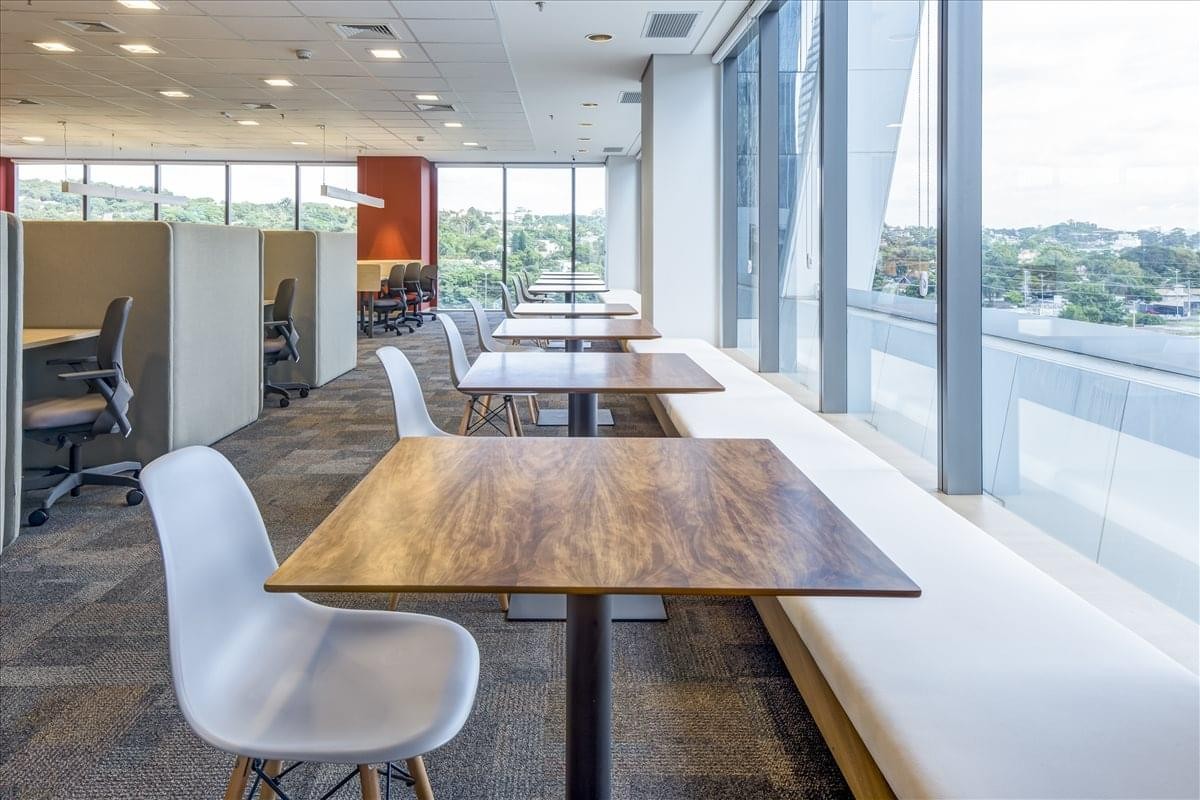 Modern reception area at JK Complex, Tower B with a light wood desk and white guest seating.