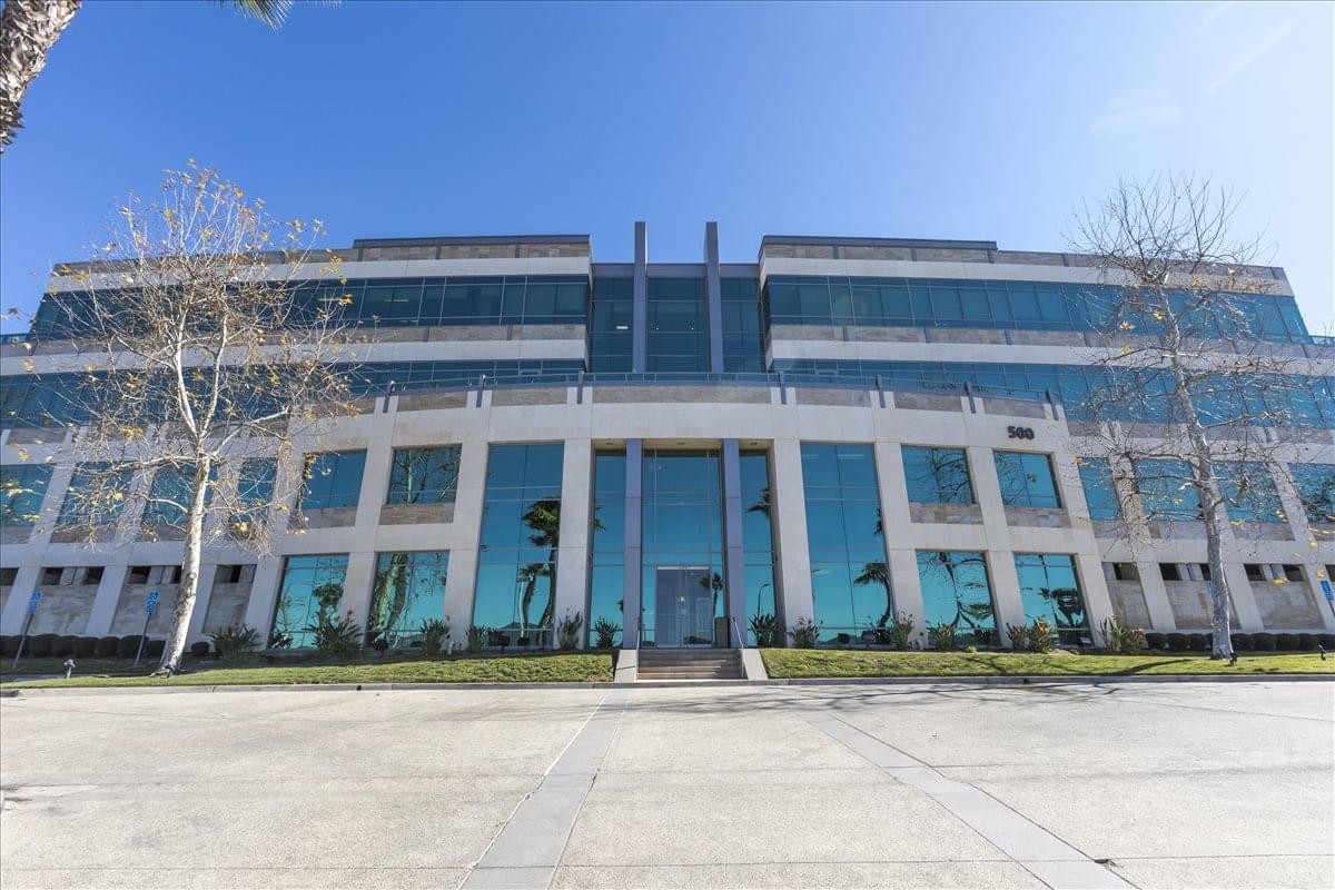 Exterior view of the glass-facade La Terraza Corporate Plaza with manicured landscaping.