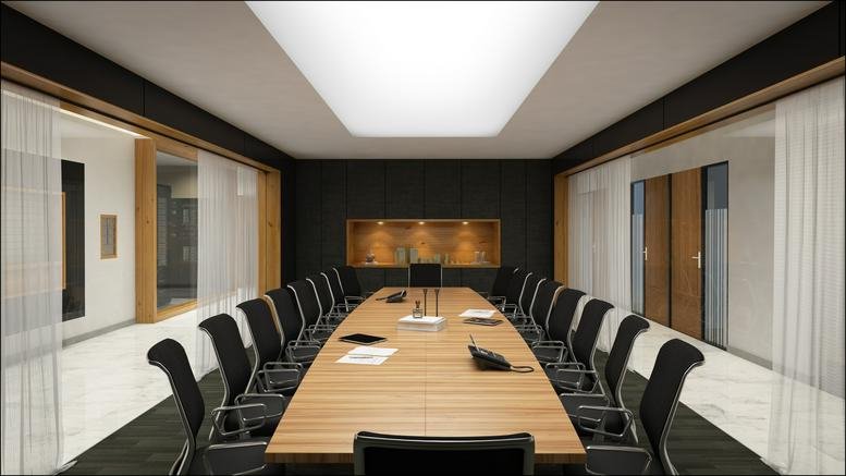 Large boardroom featuring a long wooden table and sleek black seating.