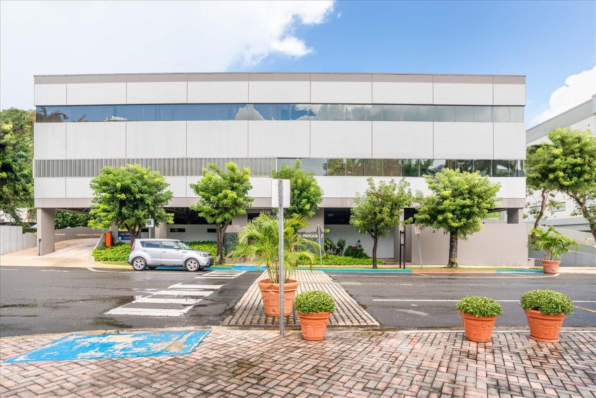 Exterior view of the contemporary low-rise Metro Office Park building with tropical landscaping.