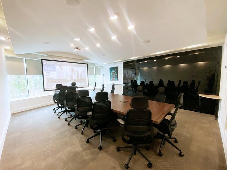 Contemporary Miravalle, Calzada San Pedro 250, Norte Col. conference room with a large wooden table and dark accent wall.