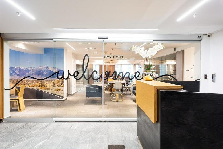 Bright reception area with a branded welcome glass wall at Monte Elbruz 124 Piso 2 Col. Palmitas.