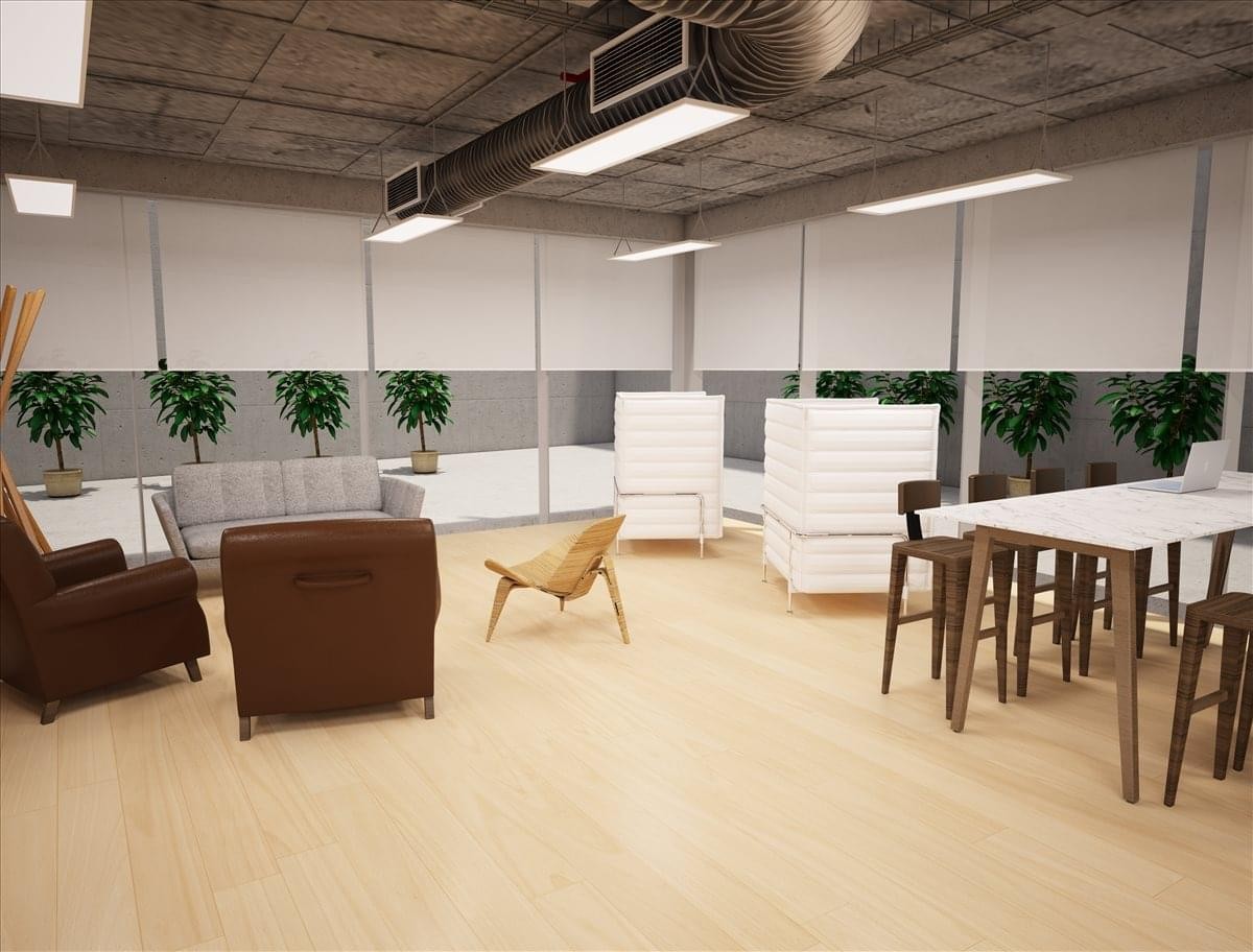 Spacious communal lounge with diverse seating, potted plants, and exposed ceilings.