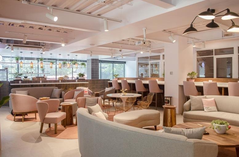 Spacious communal lounge at Montes Urales 455 piso 1 y 2 with pink velvet armchairs and warm lighting.