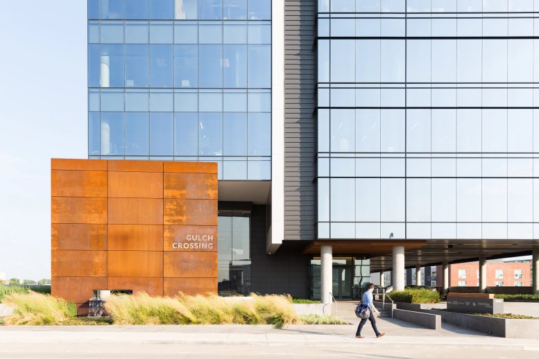 Exterior view of the modern glass facade at Gulch Crossing with rusted metal architectural details.