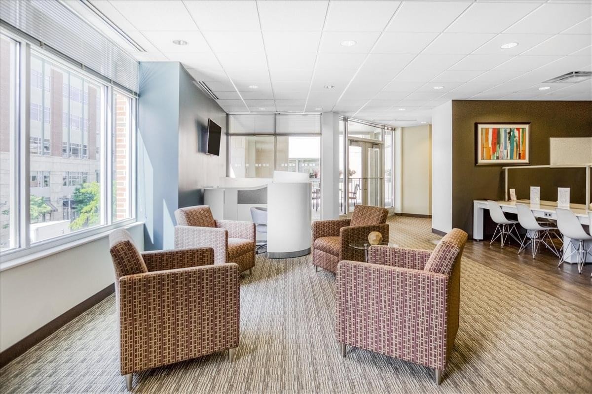 Modern reception desk at North Shore Place II with a bright orange feature wall.