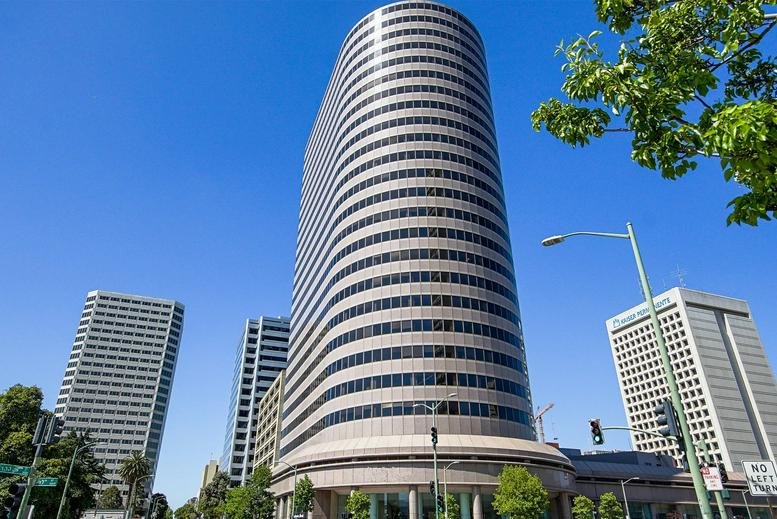 Exterior view of the curved glass facade of Lake Merritt Plaza.