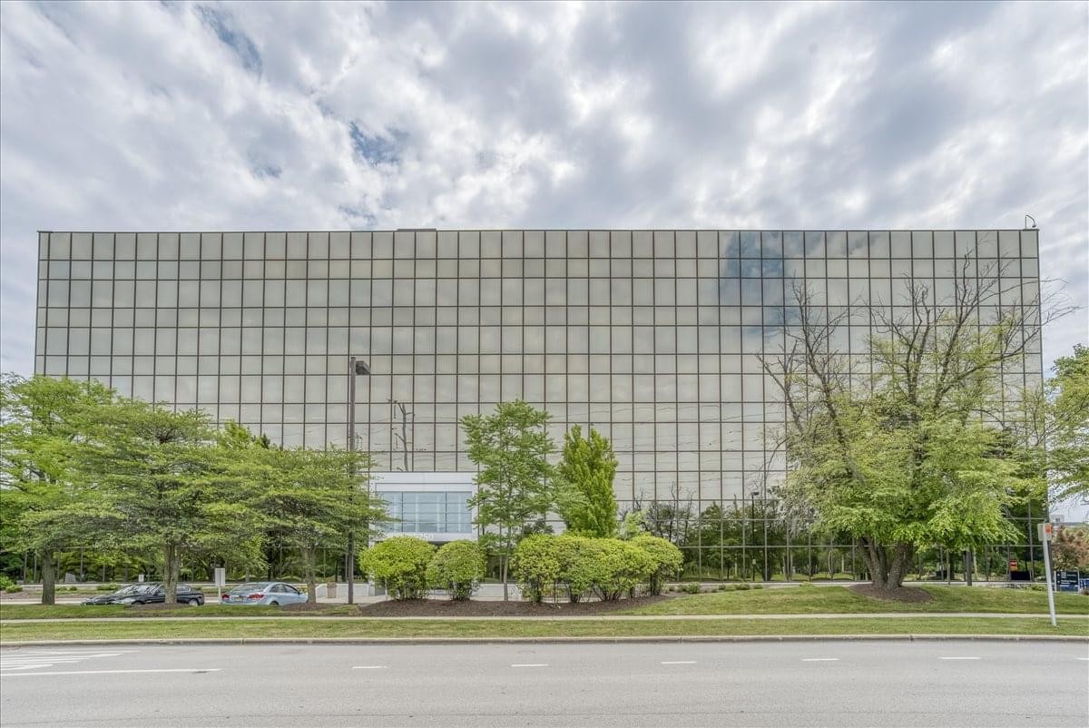 Exterior view of the wide, multi-story glass building at Old Orchard, 5250 Old Orchard.