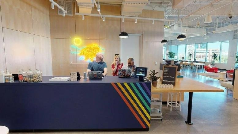 Reception desk with rainbow stripes and modern lounge area at One Glenwood, 1 Glenwood Avenue.