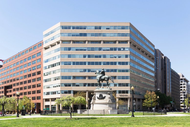 Exterior view of the tan and glass facade building at One Thomas Circle NW.