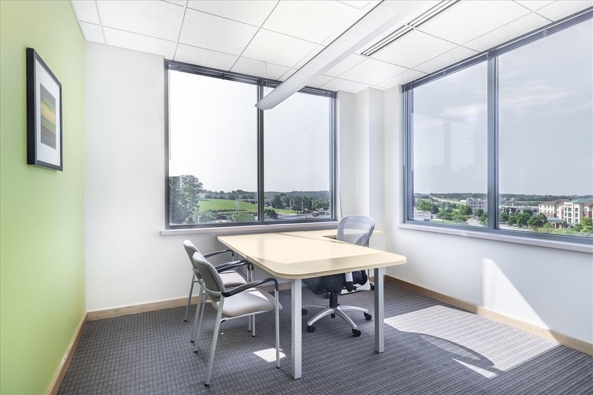 Exterior view of Park Bank Plaza with trees and parked cars.