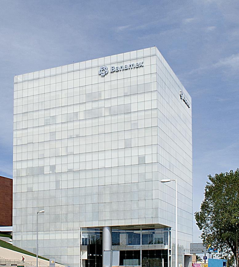 Exterior view of the white grid-facade office building at Patria 2085 Plaza Andares.