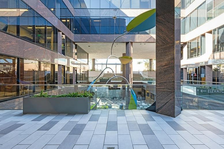 Exterior view of the modern glass and stone facade at Camelback Commons.