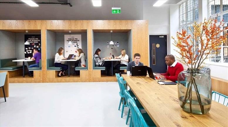 Communal breakout area with booths and a long table.