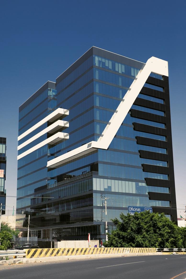 Exterior view of the blue-glass and white-accented facade of Torre 57.