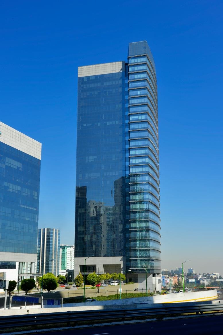 Exterior view of the glass-facade skyscraper at Prolongación Paseo de la Reforma 1015, Santa Fe.