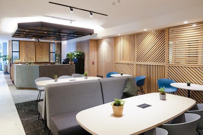 Professional reception area with a gray stone desk and decorative wood partitions.