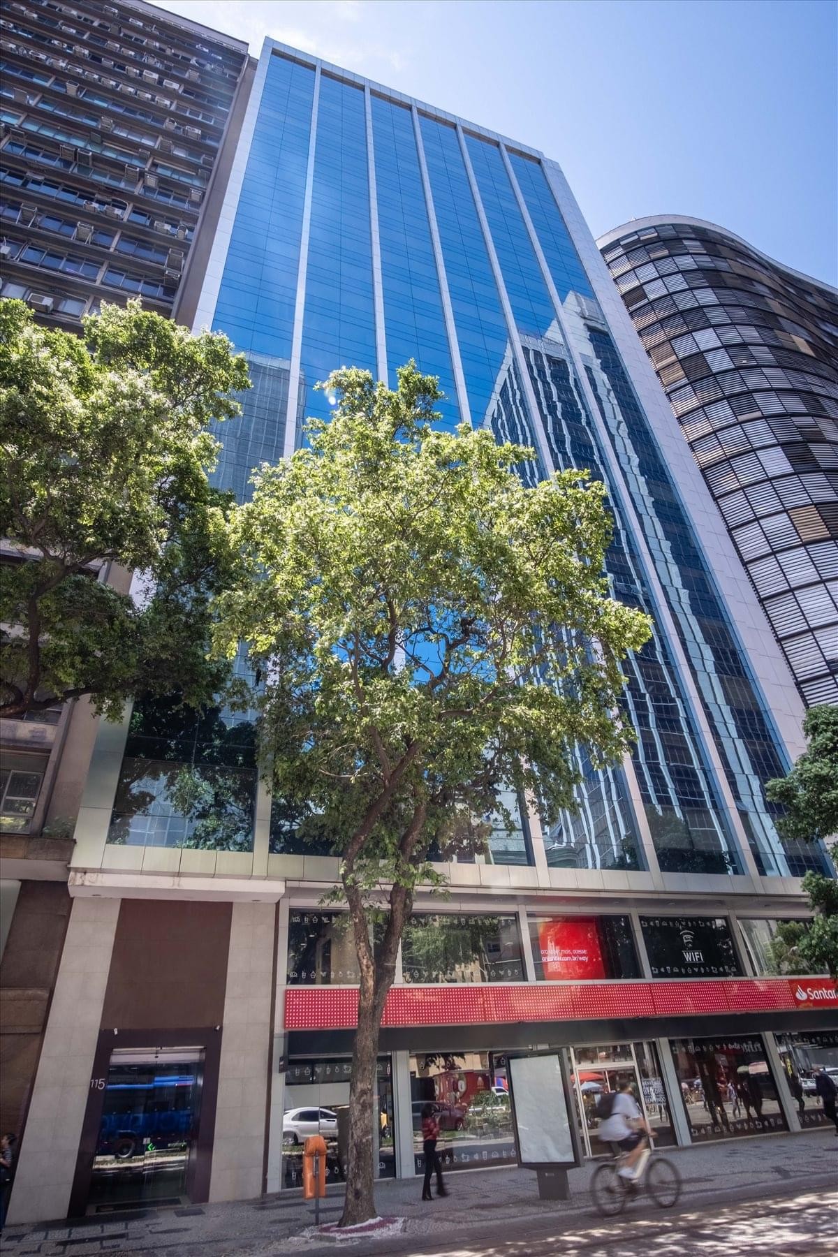 Exterior view of the glass-facade RB115 Building soaring above Rio Branco Avenue.