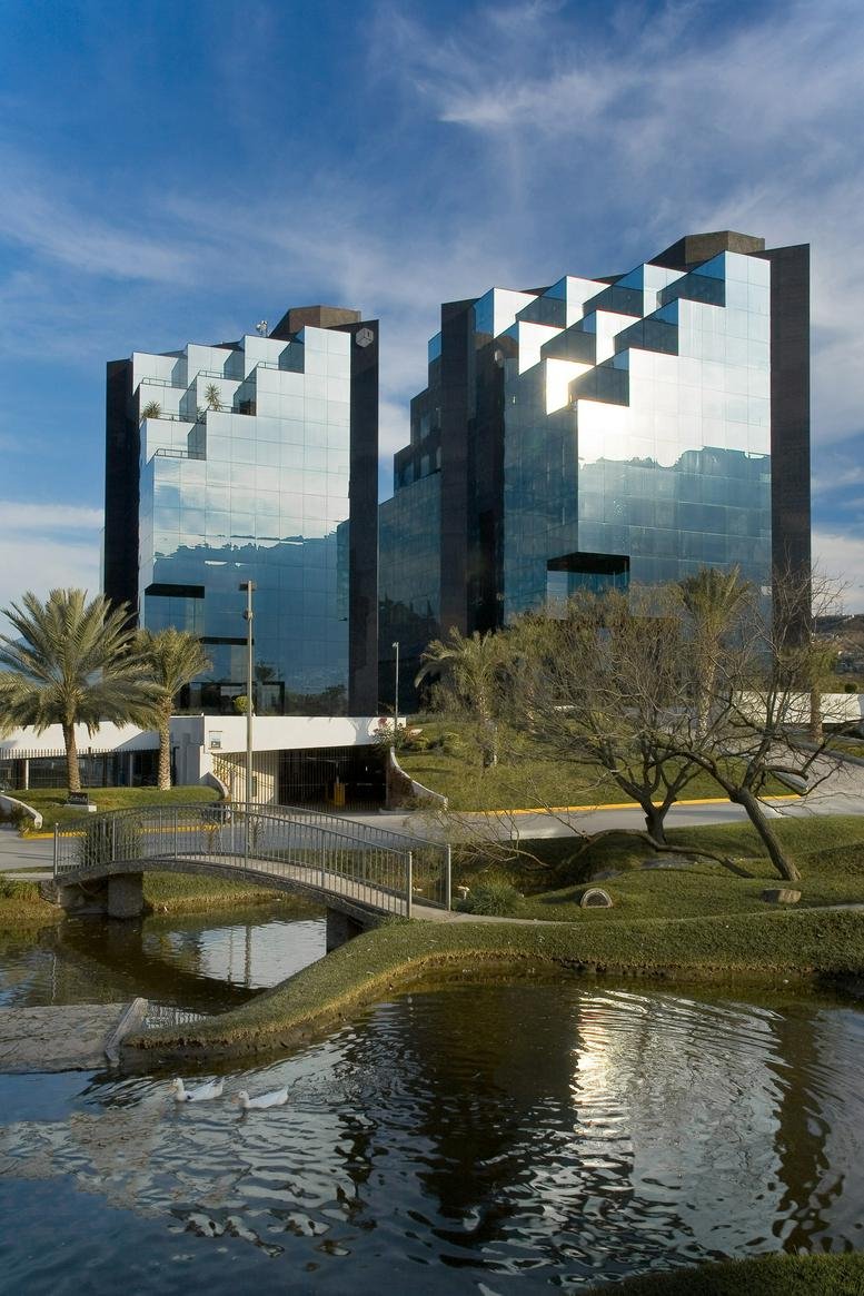 Exterior view of the modern glass and stone facade of Torres IOS Campestre.