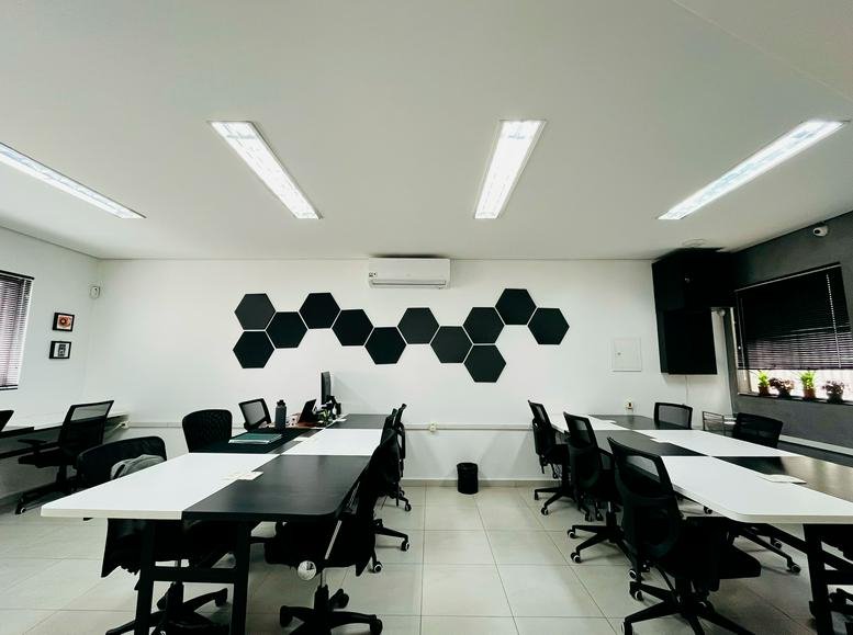 Spacious open-plan workspace at Rua Doutor Gabriel Piza, 577, Santana, São Paulo, Brazil with hexagon wall art.