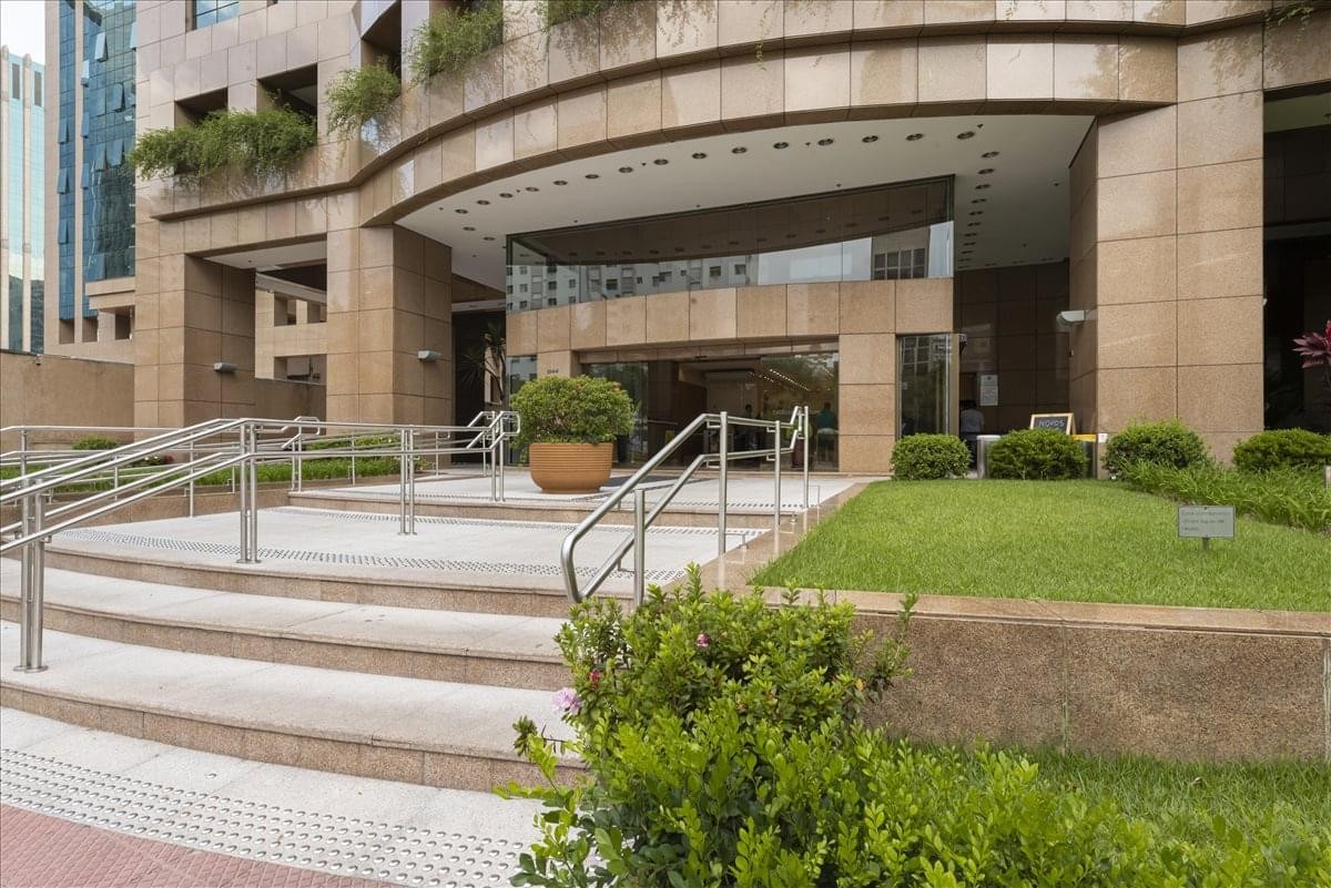 Exterior entrance of the Seculum Building (3F) with stone facade and landscaped stairs.