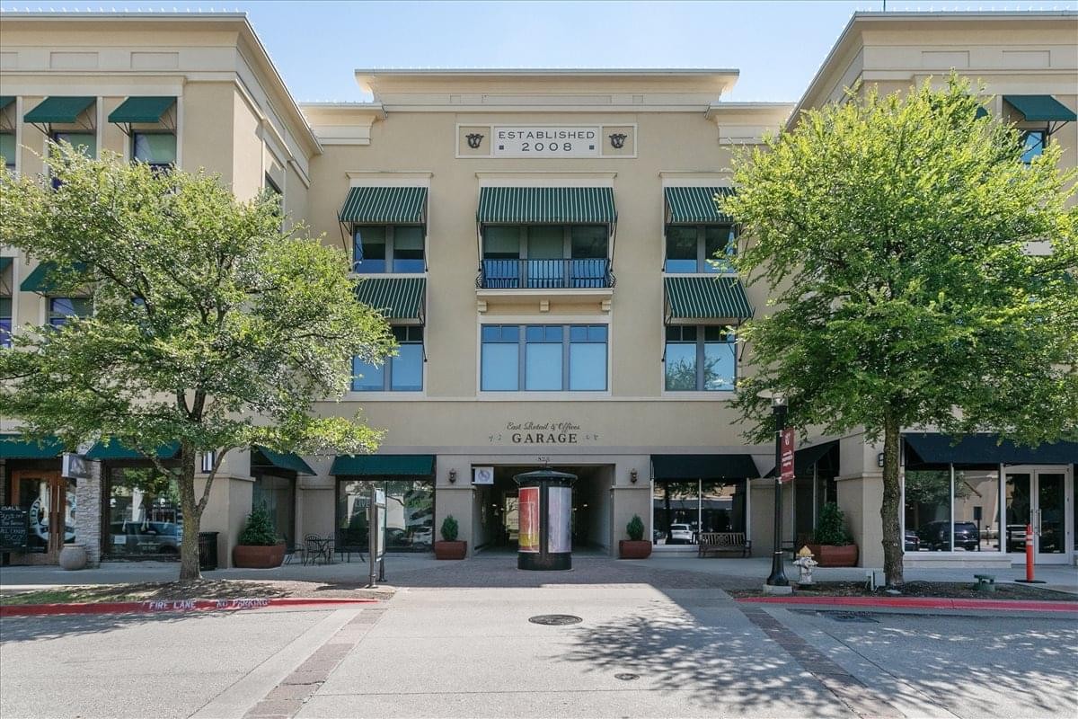 Exterior view of the multi-story building at 825 Market Street, Building M with green awnings.
