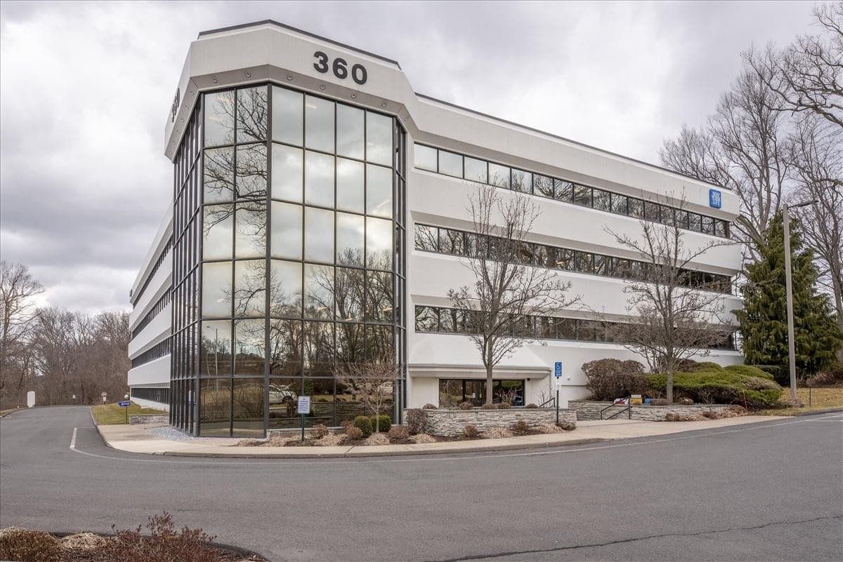 Exterior view of the four-story white and glass facade office building at 360 Bloomfield Avenue.