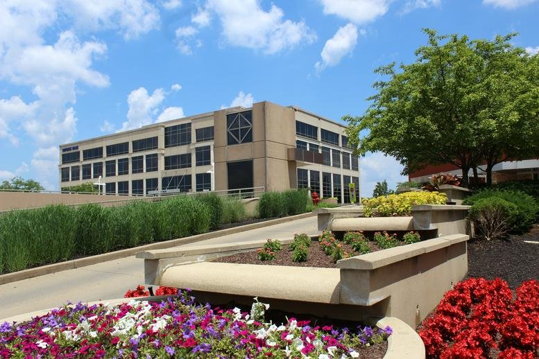 Exterior view of the office building at Suite 550, 3805 Edwards Road with manicured gardens.