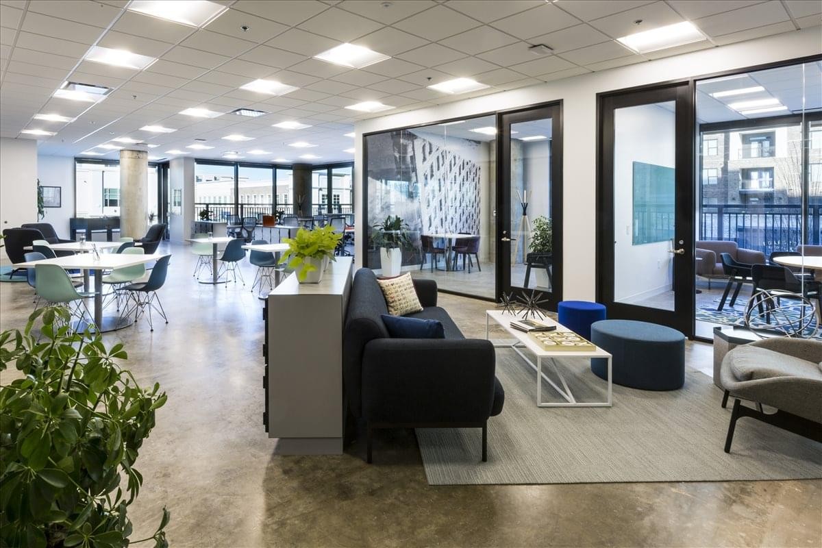 Reception desk at The Avalon Center featuring a white counter and industrial staircase.