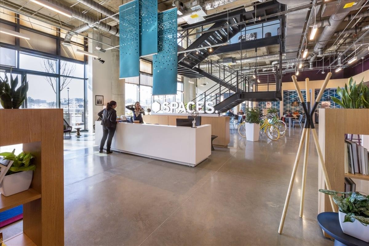 Reception area of The Avalon Center with sleek white desk and blue hanging panels.