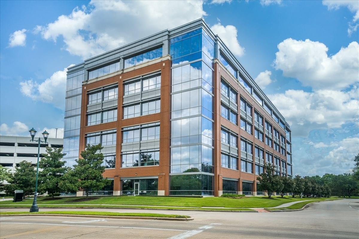 Exterior view of the brick and glass facade of Three Sugar Creek Center.