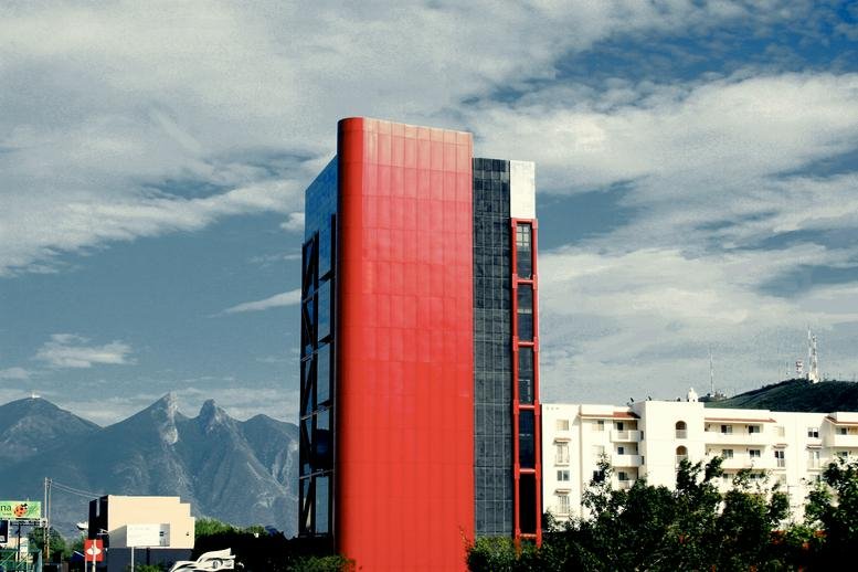 Exterior view of the modern red and glass facade at Torre GIA.