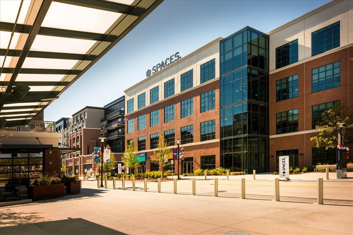 Exterior view of the brick facade and glass entrance of Two Ballpark Center, SPACES Atlanta.