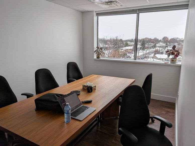Meeting room with wooden table and snowy window views