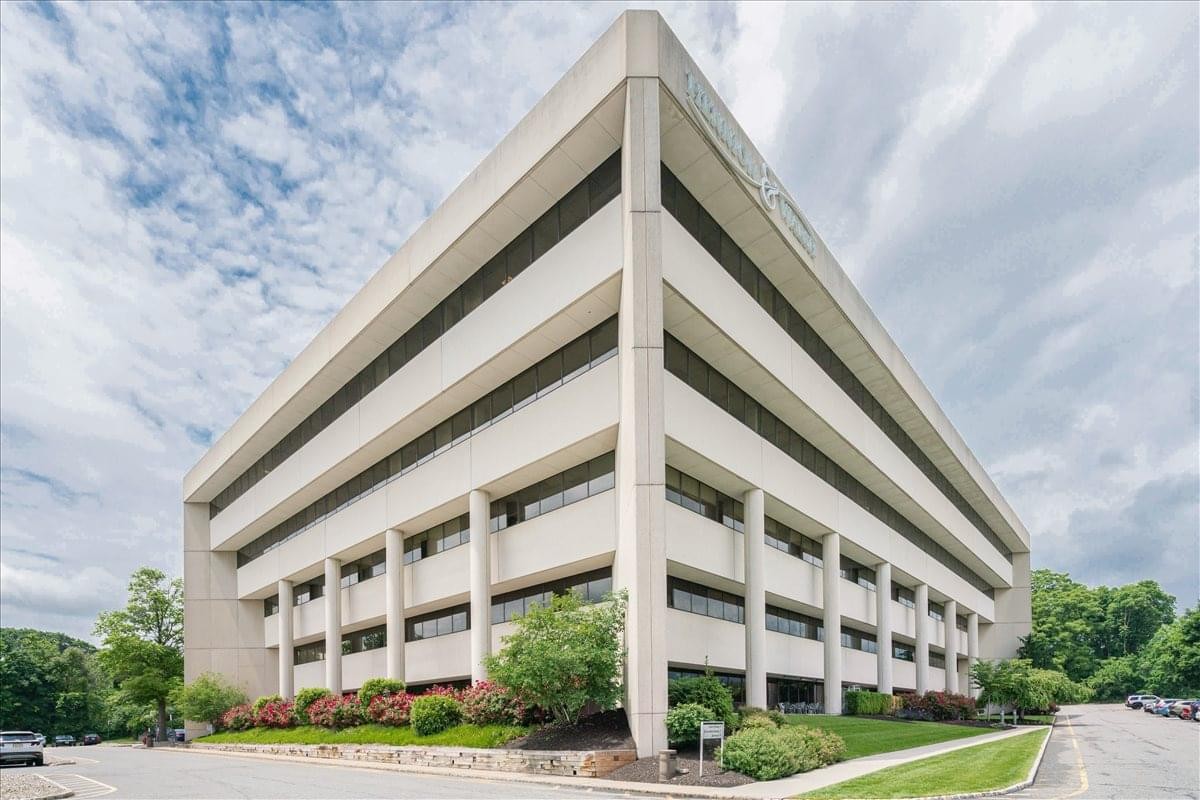 Exterior view of the white multi-story Waterview Plaza office building under a blue sky.