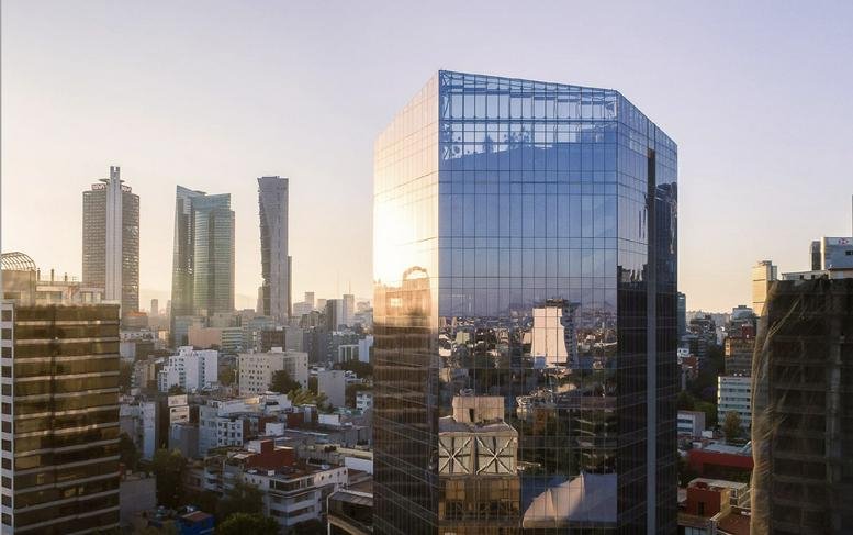 Exterior view of the glass-facade Plaza Villa Madrid no. 1 skyscraper at sunset.