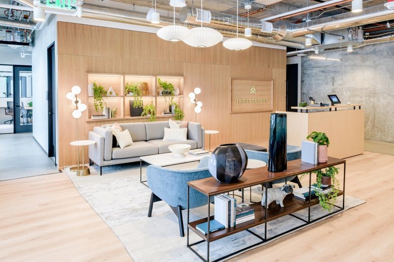 Spacious reception area with a wood-paneled feature wall and modern grey seating at Rainier Square.