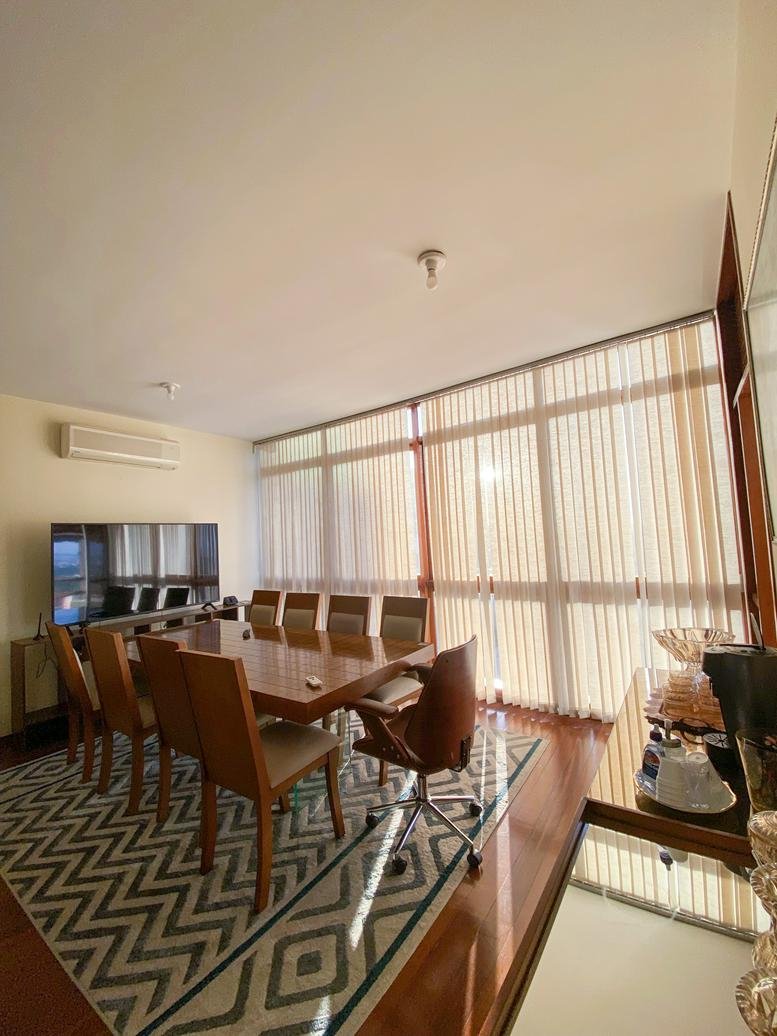 Bright dining area or meeting space at Rua Desembargador Paulo Mota, 594 with large windows and wooden table.