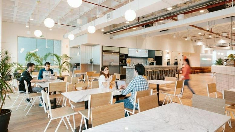 Large open-plan coworking space at Rua Flórida, 1970, Brooklin, Sao Paulo with wooden finishes.