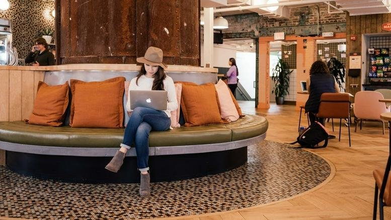 Spacious communal lounge at Rua Sergipe, 1440 Belo Horizonte with curved seating and warm orange pillows.