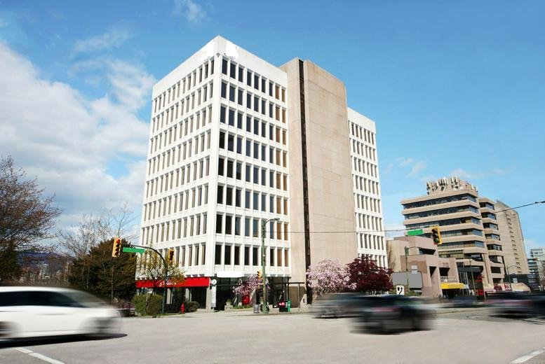 Exterior view of the white Scotiabank Building at 999 West Broadway with blue sky.