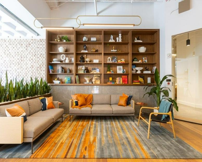 Spacious communal lounge at Texas Tower, 845 Texas Avenue featuring stylish shelving and warm wood accents.