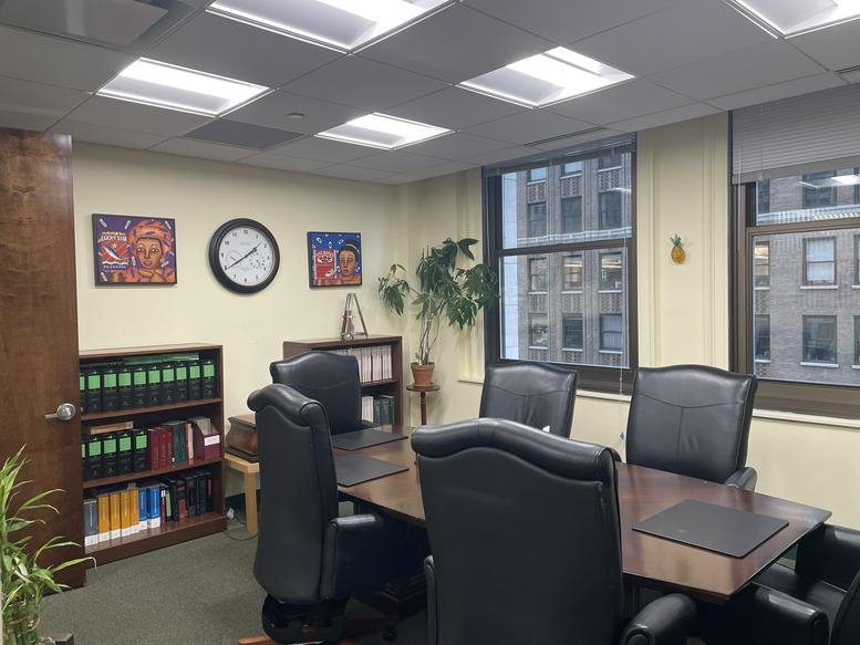 Spacious boardroom at The Woolworth Building, 233 Broadway, Suite 801, with leather chairs and city views.