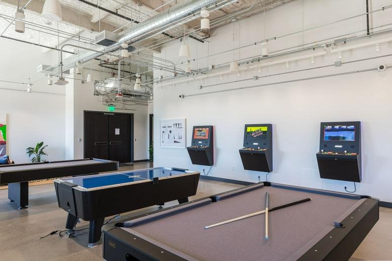 Spacious game room at Town Square, 6543 South Las Vegas Boulevard featuring pool tables and arcade machines.